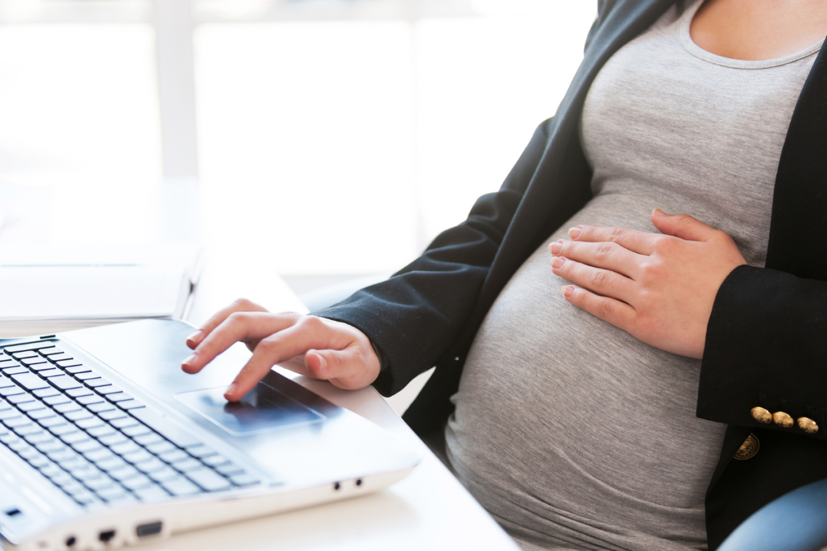 Pregnant woman at computer