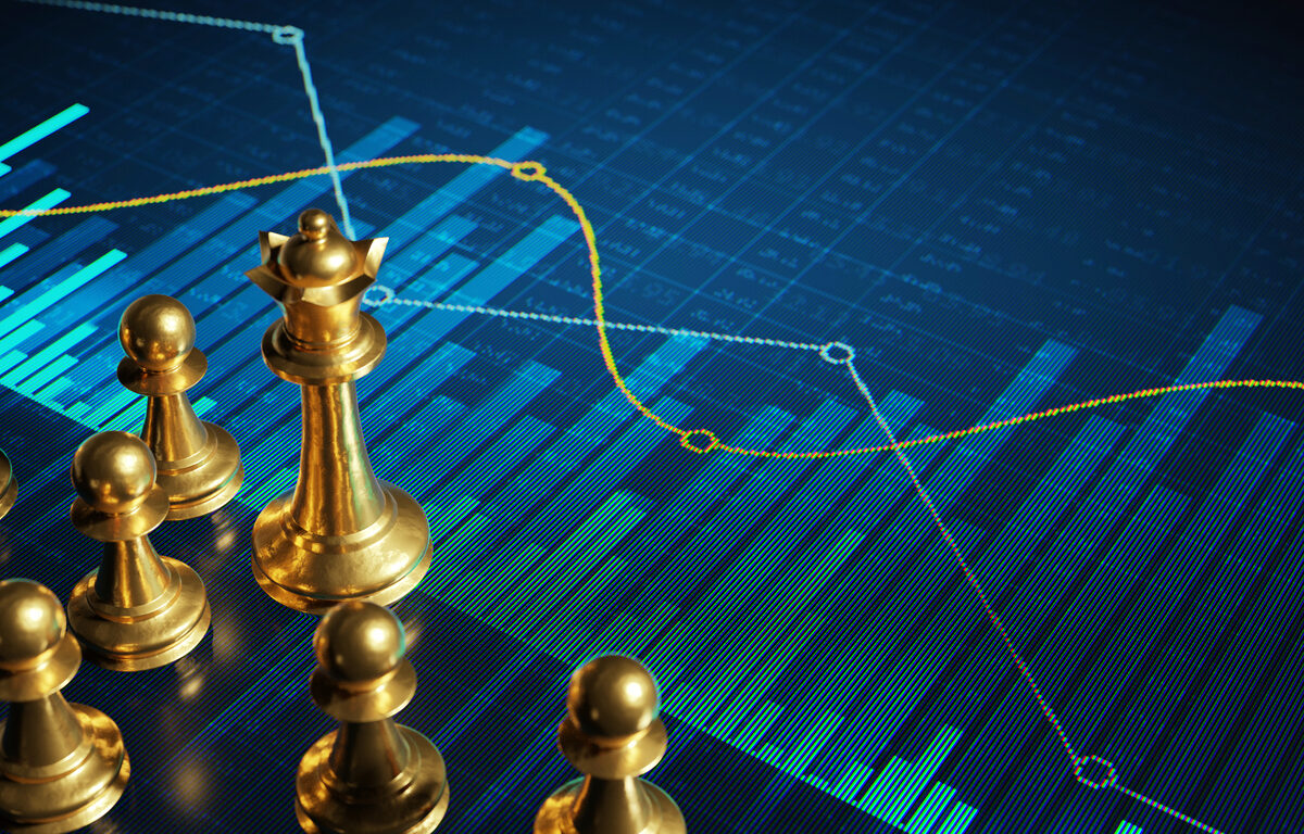 Golden chess pieces on digital display with financial charts