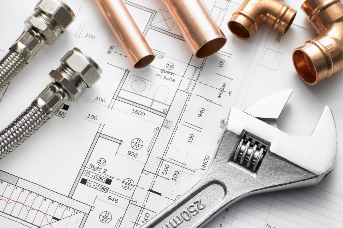 Closeup shot of plumbing equipment on house plans